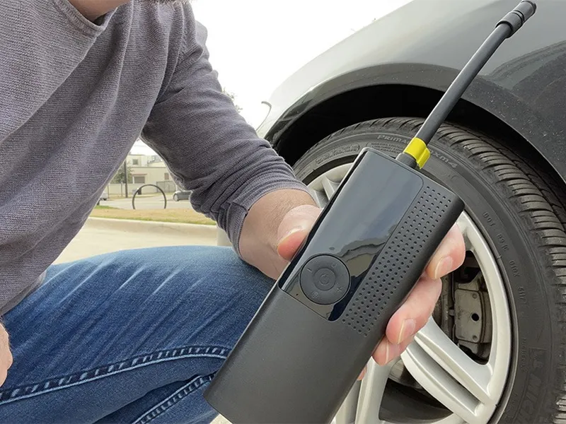 Airmoto inflator connected to a car tire